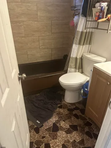 a bathroom with a toilet and a shower