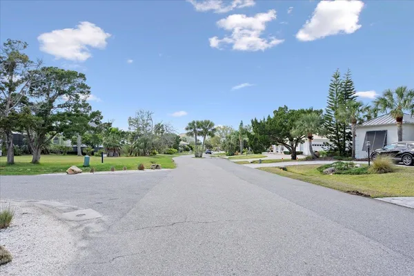 a view of a house with a yard and a garage