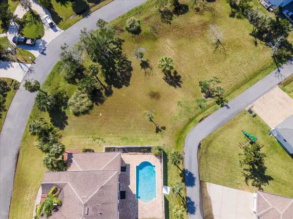 an aerial view of a house with a swimming pool