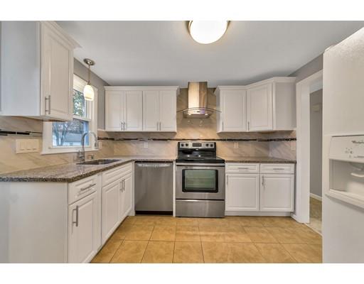 106 Fallston Street Springfield, MA 01119 - Photo 3 of 14 a kitchen with granite countertop a sink stainless steel appliances and cabinets