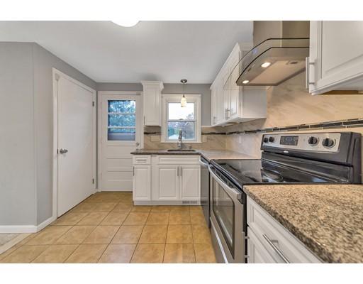 106 Fallston Street Springfield, MA 01119 - Photo 10 of 14 a kitchen with stainless steel appliances granite countertop a sink stove and cabinets