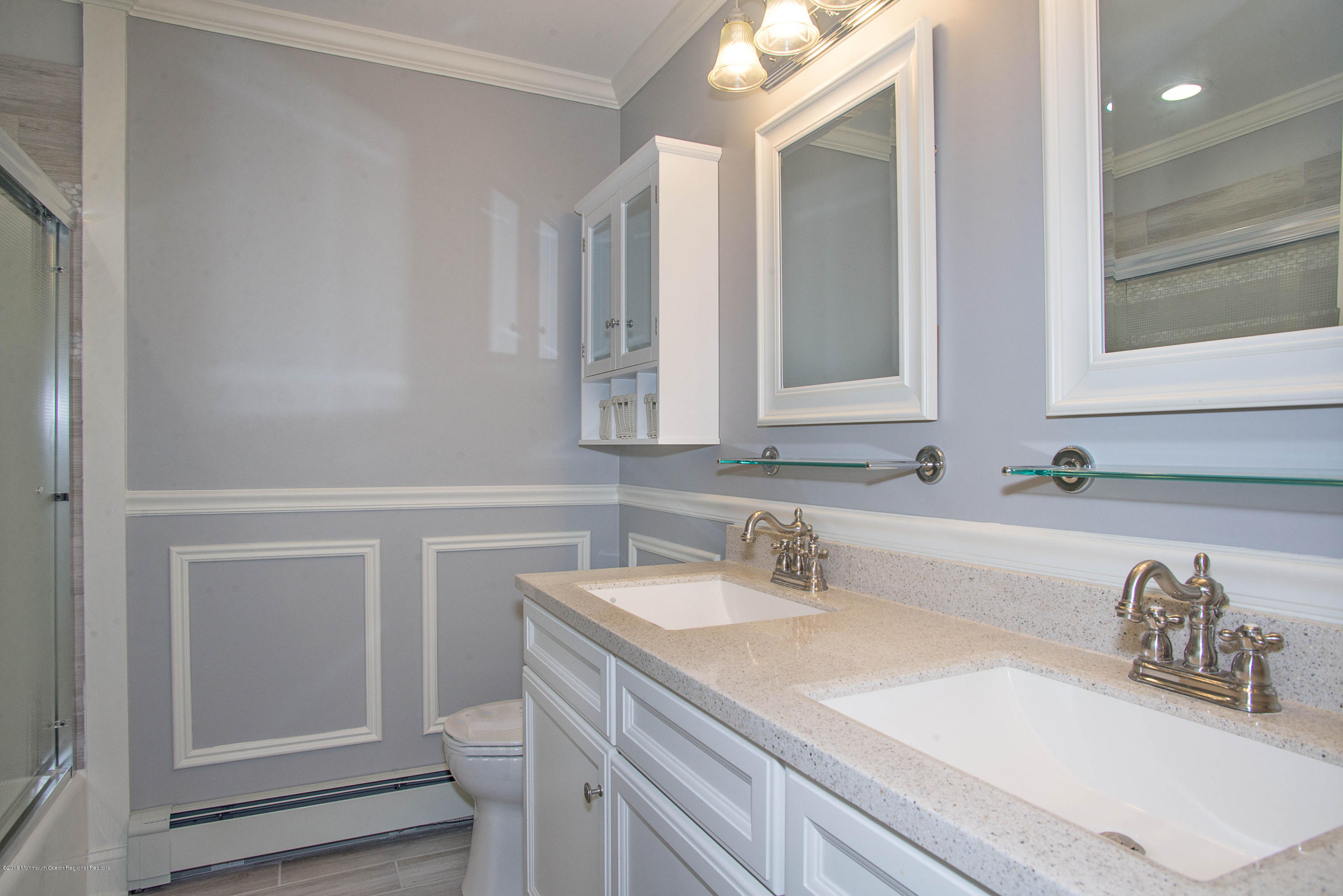 435 Burlington Road Freehold, NJ 07728 - Photo 16 of 24 a bathroom with a sink and a mirror