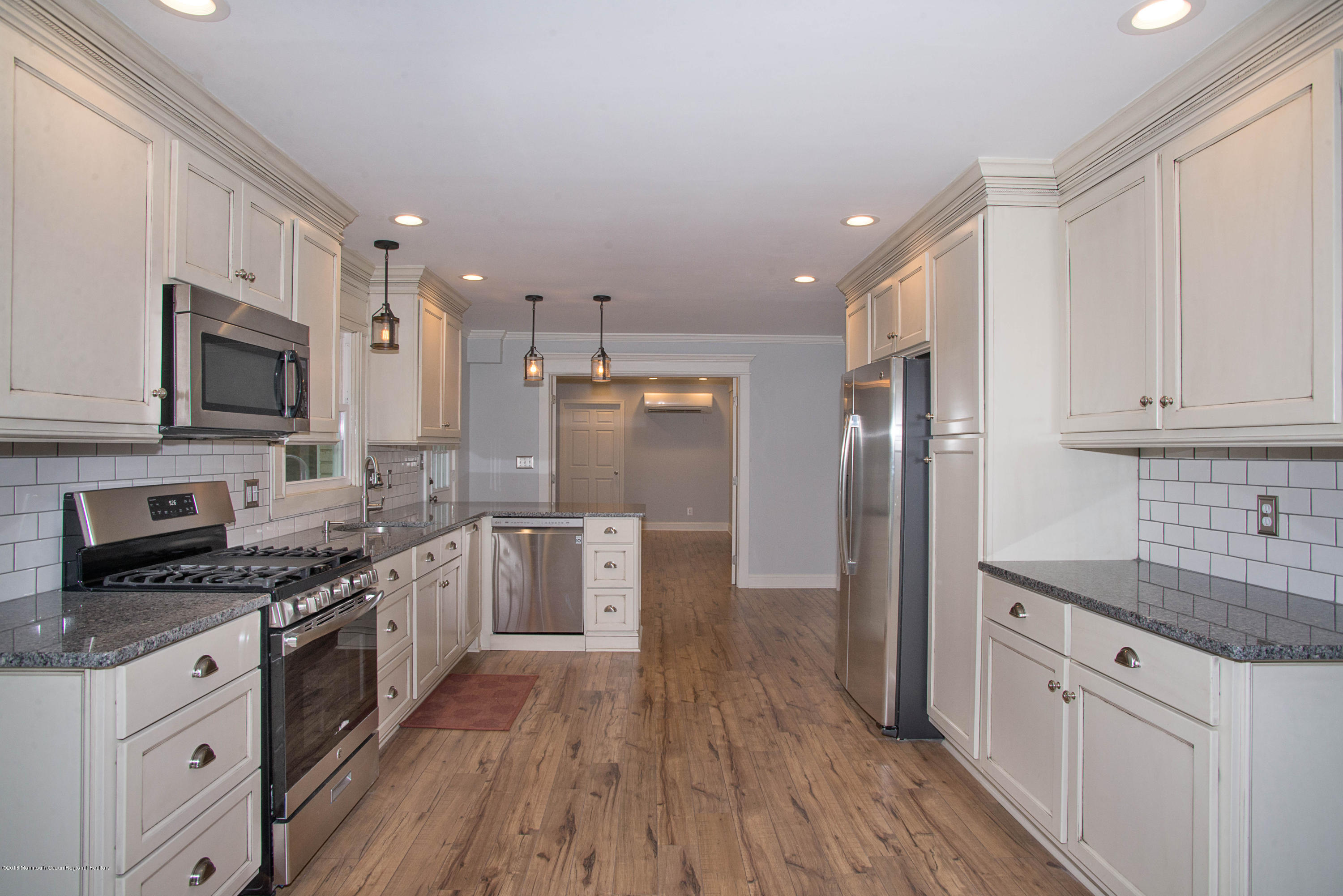 435 Burlington Road Freehold, NJ 07728 - Photo 7 of 24 a large kitchen with cabinets wooden floor and stainless steel appliances