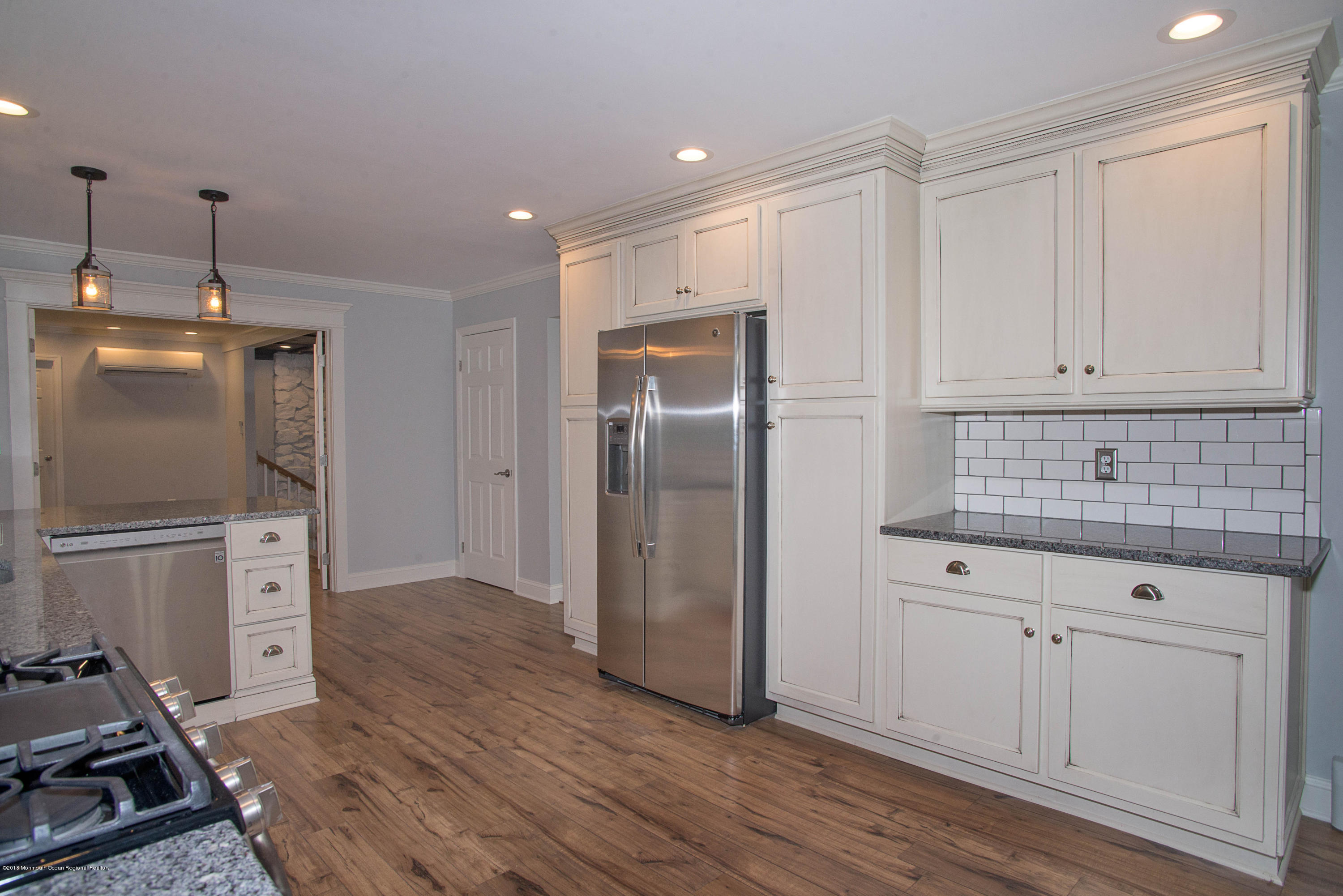 435 Burlington Road Freehold, NJ 07728 - Photo 8 of 24 a kitchen with sink refrigerator and cabinets