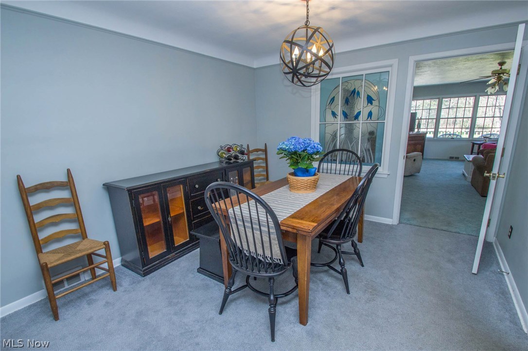 Formal Dining room with newer lighting, carpet, paint and custom stained glass window feature!