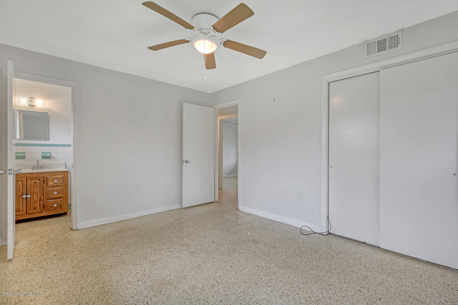 693 Bermuda Road Cocoa Beach, FL 32931 - Photo 14 of 33 an empty room with closet and a ceiling fan