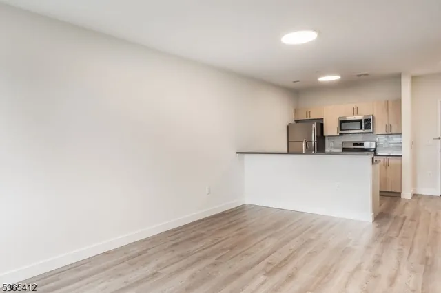 a view of a kitchen with wooden floor