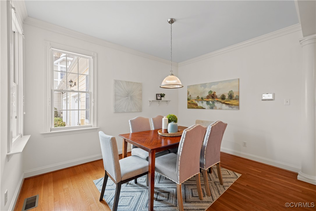 9037 Amberhill Loop Chesterfield, VA 23236 - Photo 16 of 47 a dining room with furniture a chandelier and wooden floor