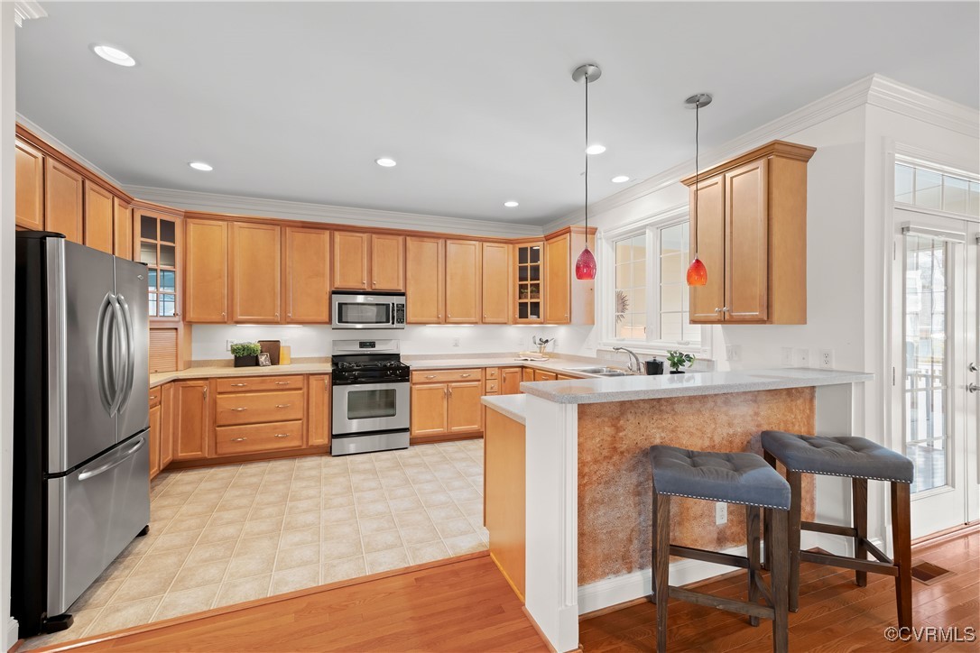 9037 Amberhill Loop Chesterfield, VA 23236 - Photo 17 of 47 a kitchen with stainless steel appliances a stove a sink a center island and a refrigerator