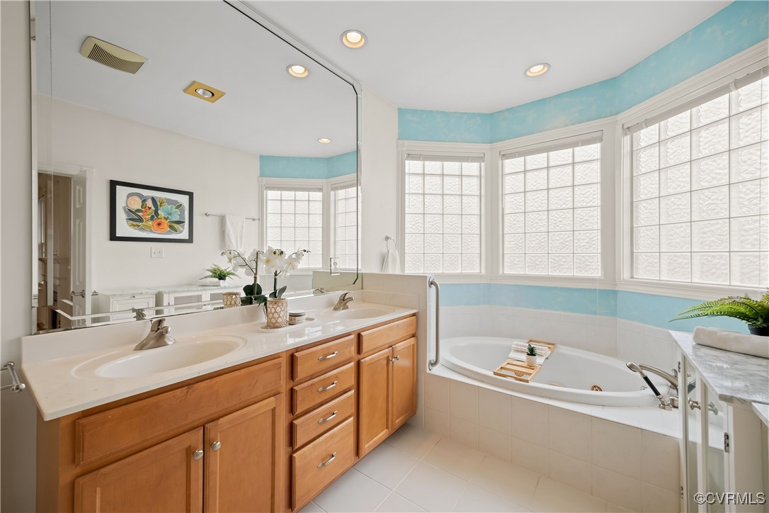 9037 Amberhill Loop Chesterfield, VA 23236 - Photo 28 of 47 a bathroom with a tub double vanity sink and mirror