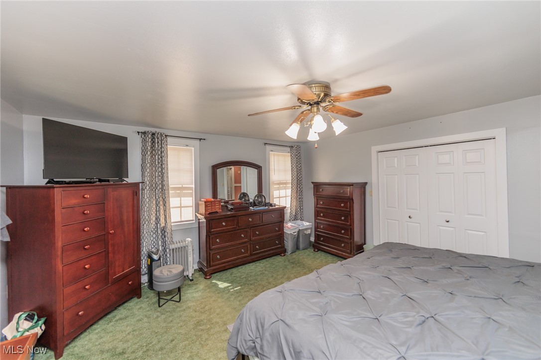 2550 North Ridge Road Vermilion, OH 44089 - Photo 32 of 50 Carpeted bedroom with ceiling fan, a closet, and radiator