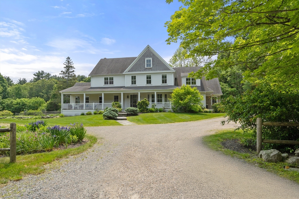 a front view of a house with yard and green space