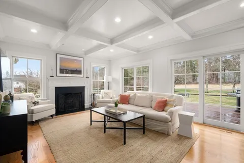 a living room with furniture a fireplace and a large window