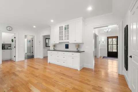a kitchen with granite countertop a stove a sink and a refrigerator