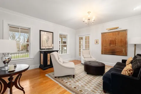a living room with furniture and a chandelier