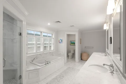 a spacious bathroom with a tub sink and shower