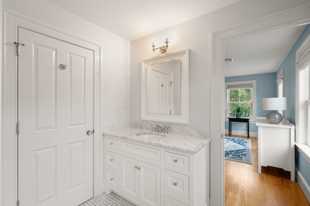 2 Snow Street Sherborn, MA 01770 - Photo 28 of 42 a spacious bathroom with a granite countertop sink and a mirror