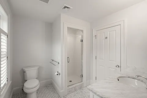 a bathroom with a sink toilet and shower