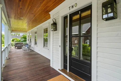 a view of a porch with wooden floor and outdoor space