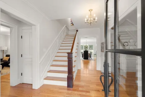 a view of entryway and hall with wooden floor