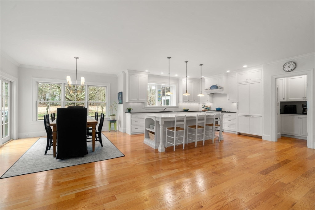 2 Snow Street Sherborn, MA 01770 - Photo 9 of 42 a dining hall with stainless steel appliances kitchen island granite countertop a dining table chairs a sink and a refrigerator