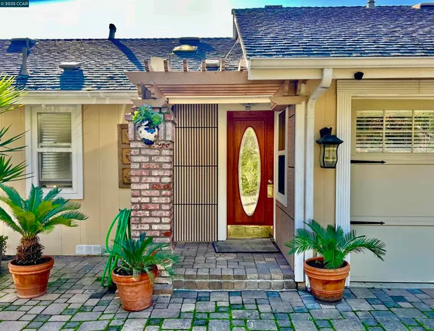 a front view of a house with a potted plants