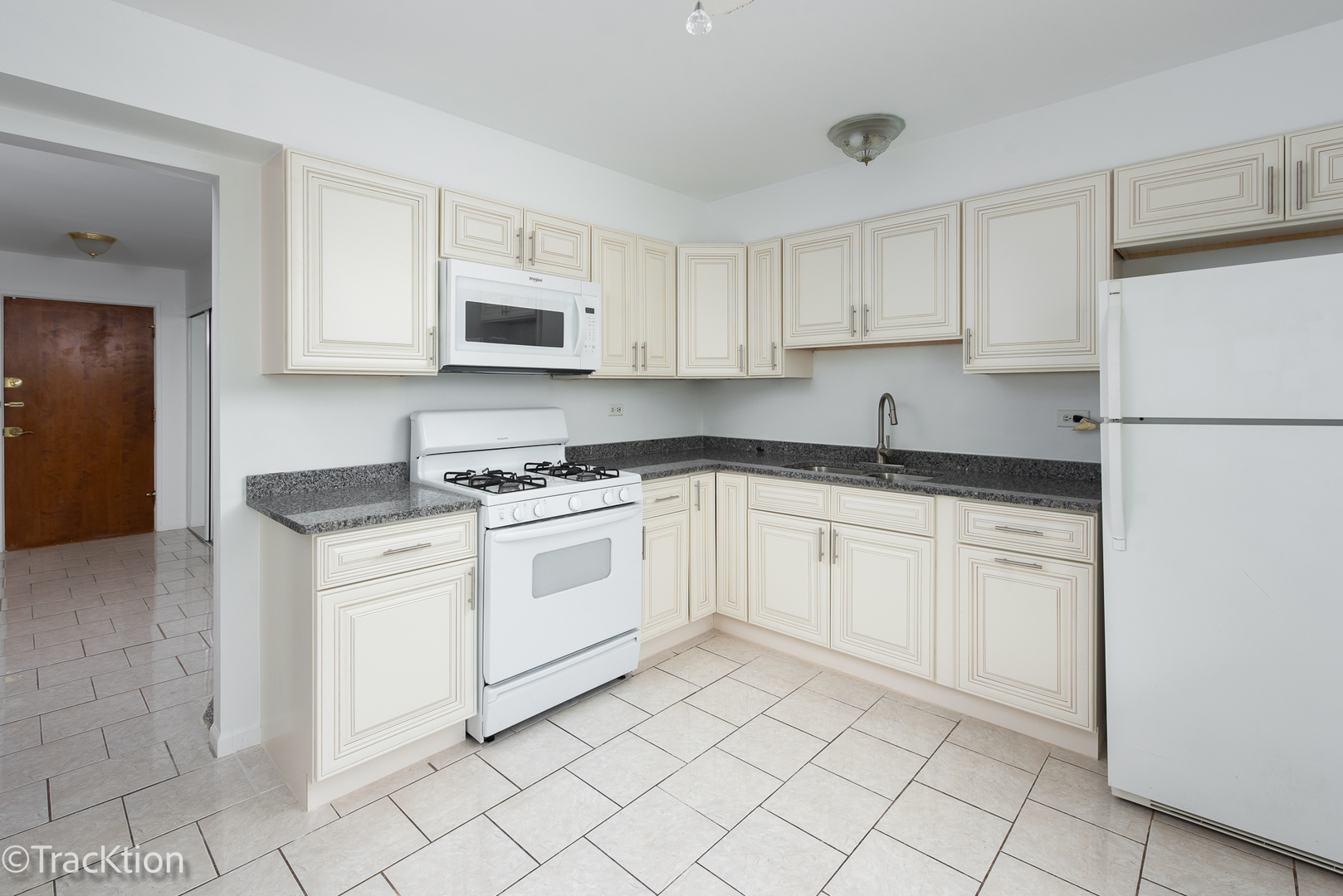 1301 South Finley Road, Unit 311 Lombard, IL 60148 - Photo 2 of 10 a kitchen with white cabinets stainless steel appliances and sink