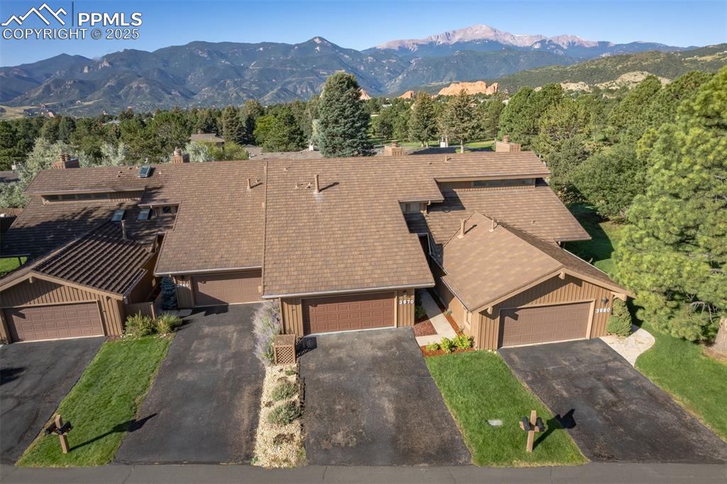 3870 Camels Ridge Lane Colorado Springs, CO 80904 - Photo 2 of 27 an aerial view of a house with a yard and mountain view