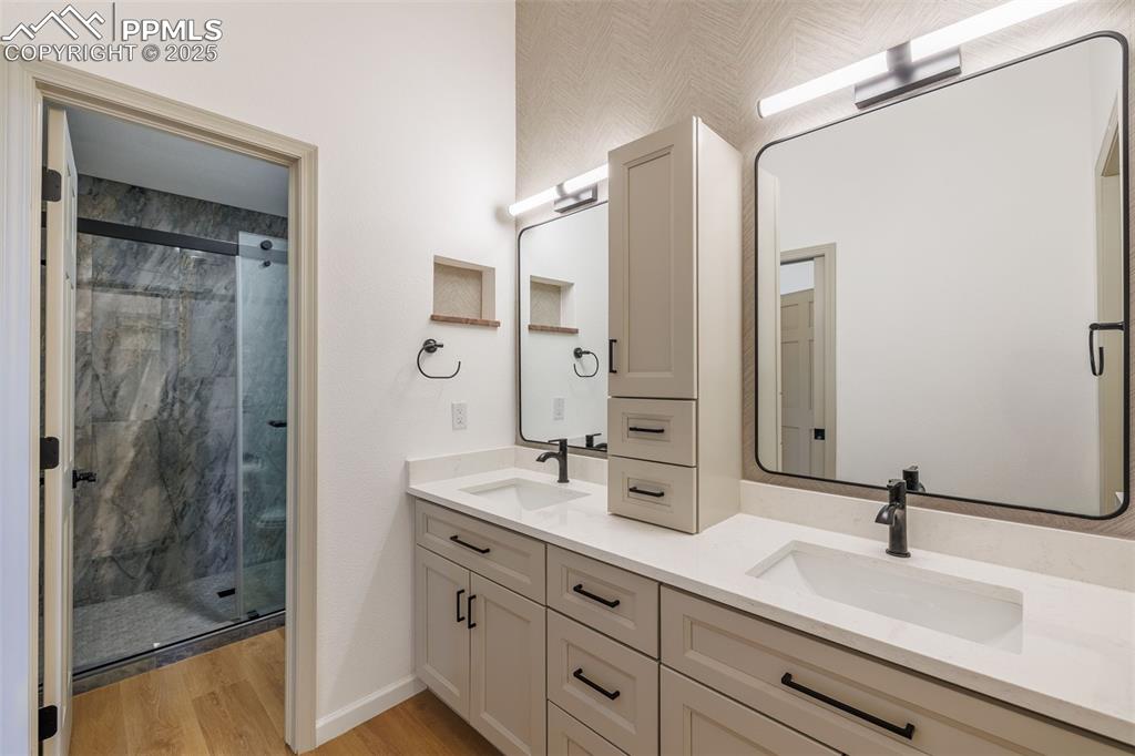 3870 Camels Ridge Lane Colorado Springs, CO 80904 - Photo 22 of 27 a bathroom with a double vanity sink mirror and shower