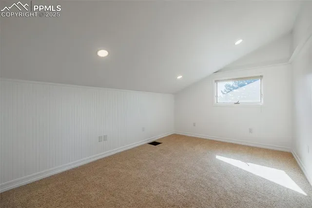 an empty room with a closet and a refrigerator