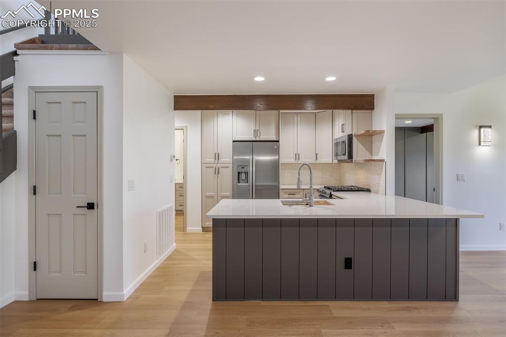 3870 Camels Ridge Lane Colorado Springs, CO 80904 - Photo 8 of 27 a kitchen with kitchen island a sink and refrigerator