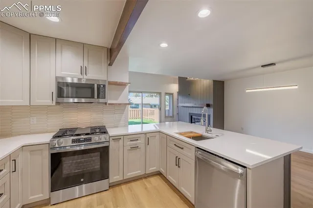 a kitchen with a sink stove and microwave