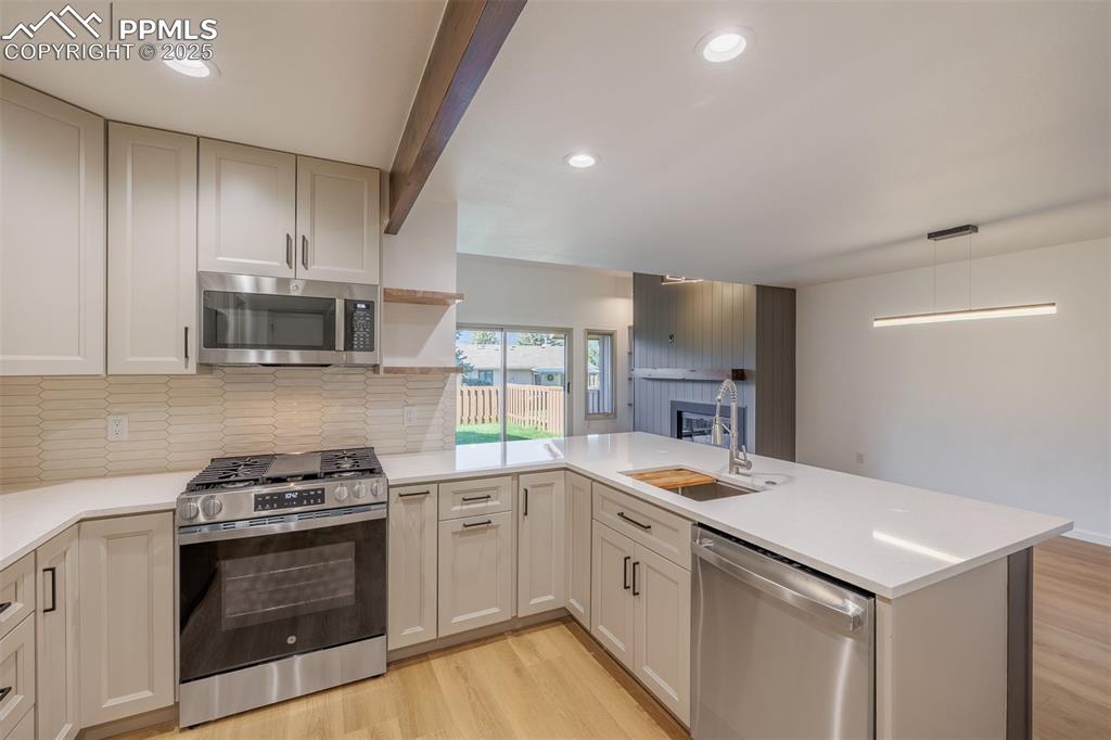 3870 Camels Ridge Lane Colorado Springs, CO 80904 - Photo 9 of 27 a kitchen with a sink stove and microwave
