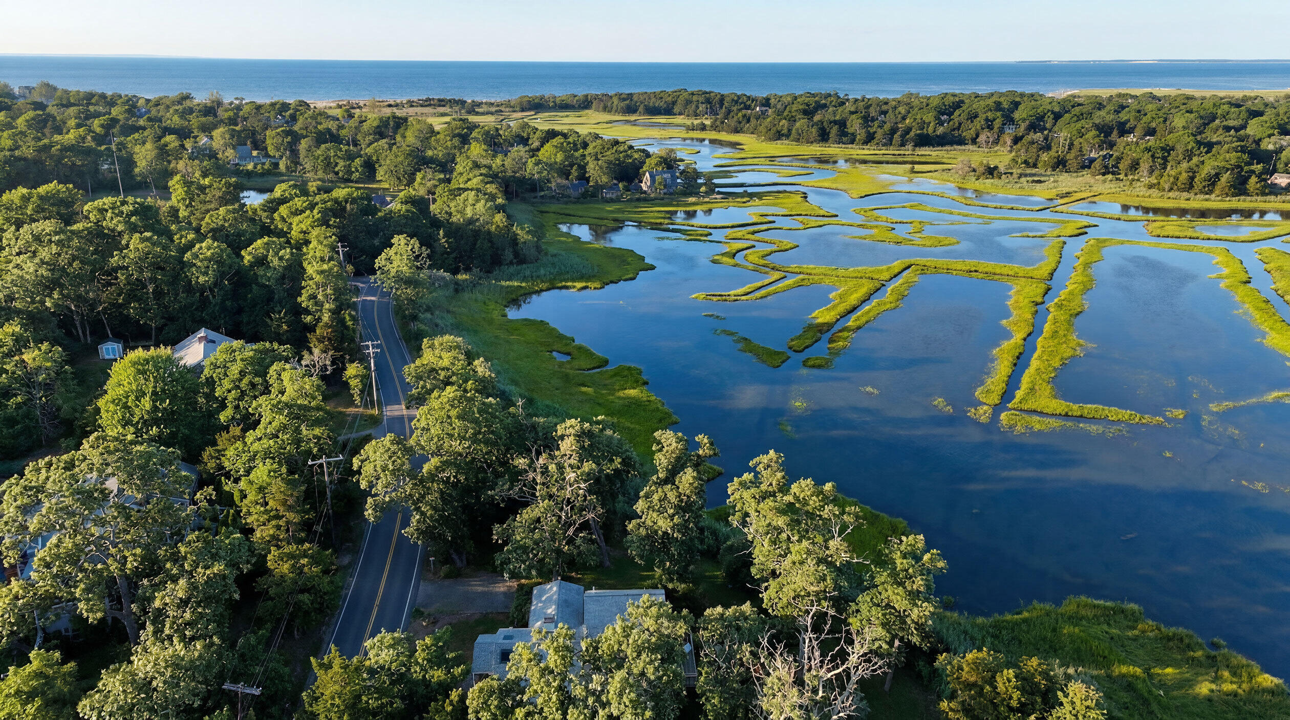 181 Rock Harbor Road Orleans, MA 02653 - Photo 3 of 16 an aerial view of a houses with a lake view