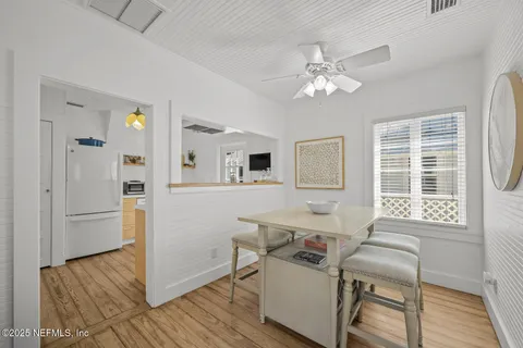a room with kitchen island and stainless steel appliances