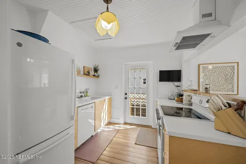 a kitchen with a refrigerator and a stove