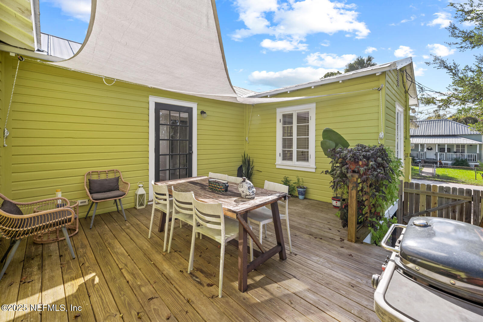 179 Blanco Street St. Augustine, FL 32084 - Photo 29 of 56 a view of a patio with table and chairs with wooden floor and fence
