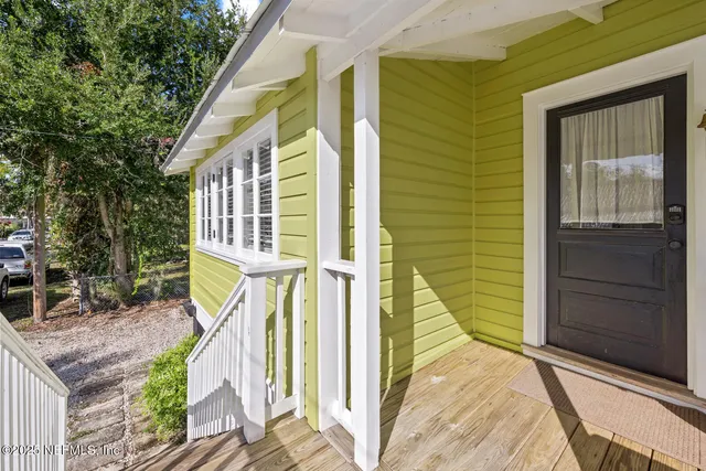 a view of a door with a chair and a couch