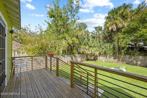 a view of a garden with trees in the background