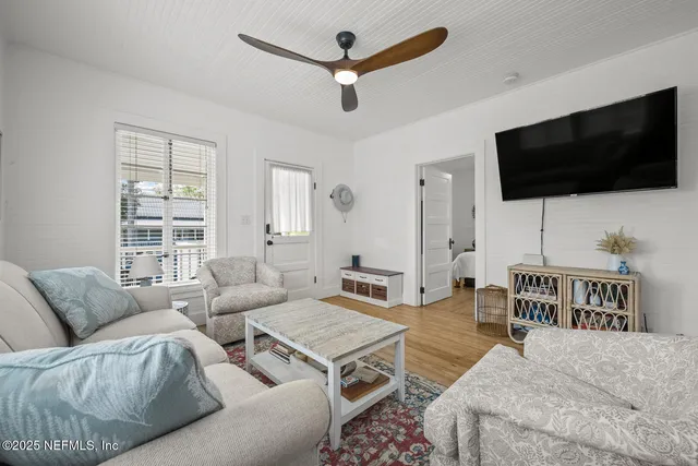 a living room with furniture and a flat screen tv