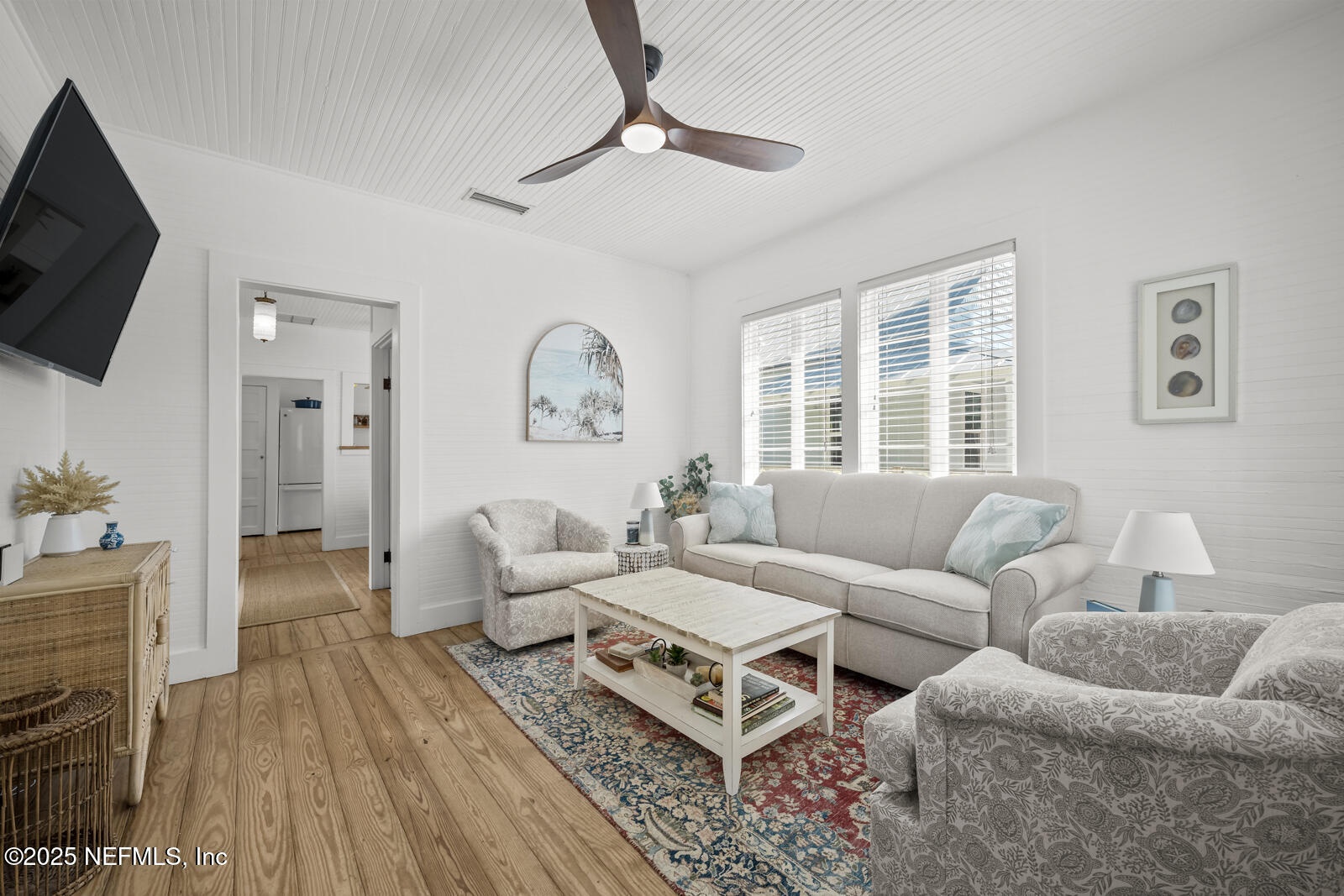 179 Blanco Street St. Augustine, FL 32084 - Photo 10 of 56 a living room with furniture a flat screen tv and a window