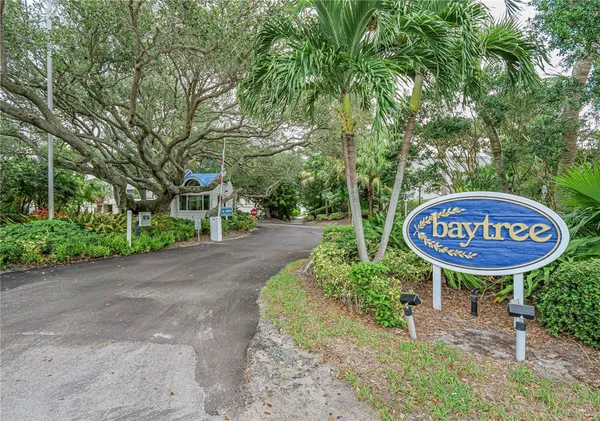 a view of a sign of a park next to a road