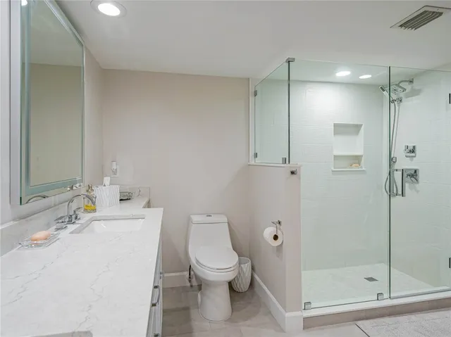 a bathroom with a toilet sink and shower