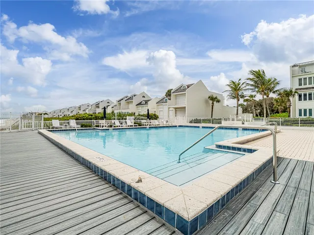a view of swimming pool with outdoor seating and barbeque oven