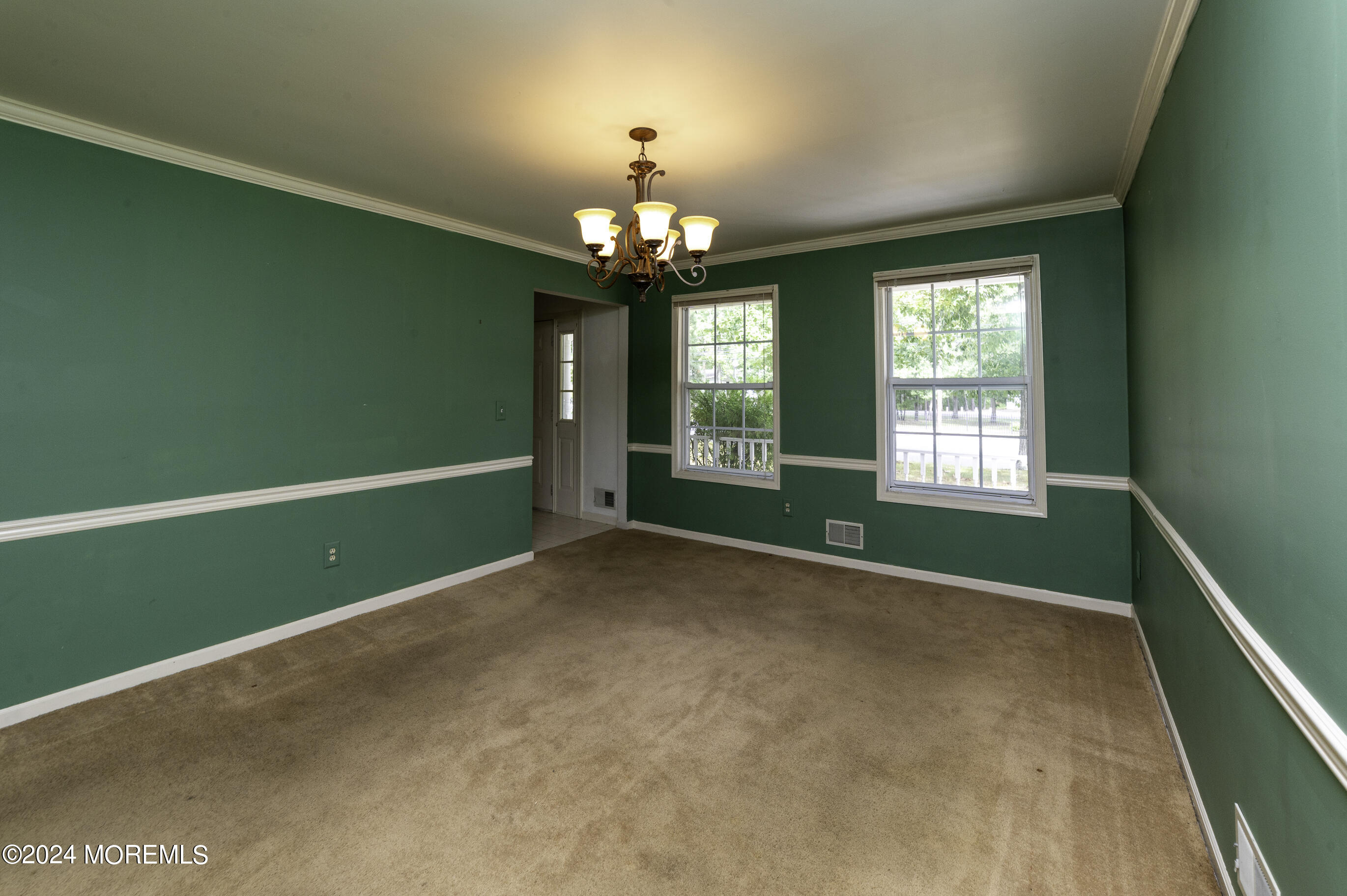 179 Wells Mill Road Waretown, NJ 08758 - Photo 12 of 28 a view of an empty room with window and chandelier