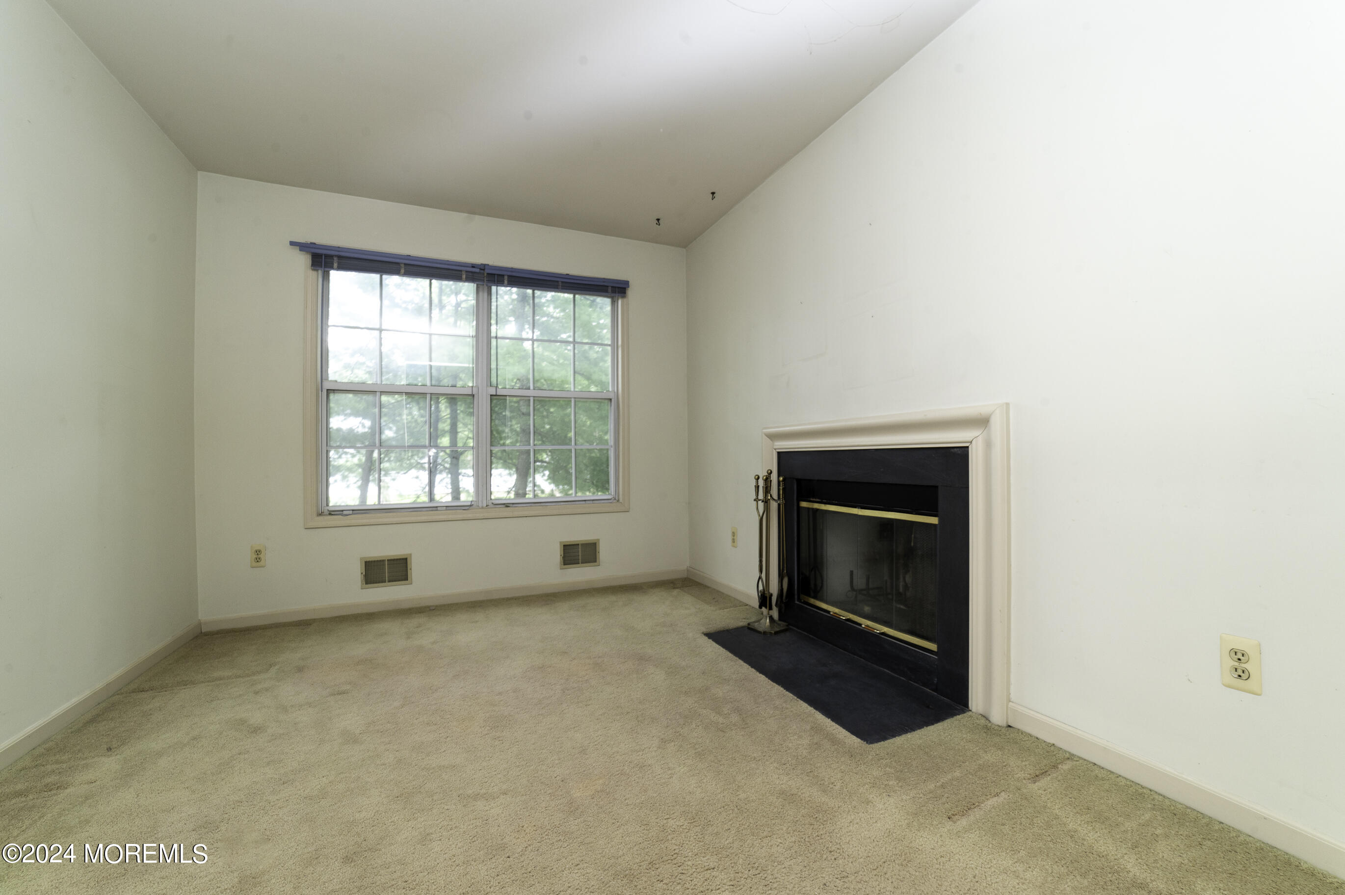 179 Wells Mill Road Waretown, NJ 08758 - Photo 14 of 28 a view of an empty room with a window and fireplace