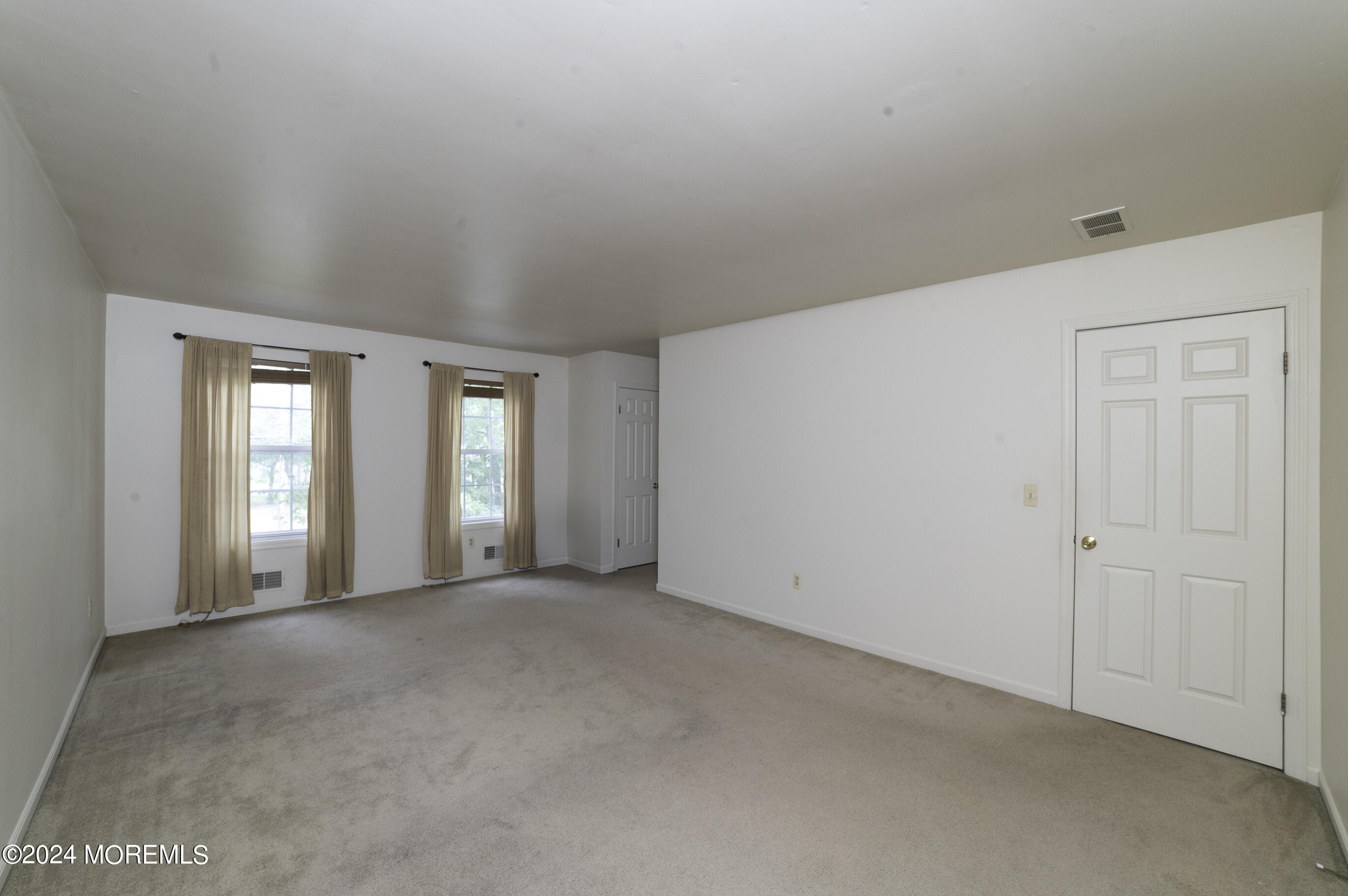 179 Wells Mill Road Waretown, NJ 08758 - Photo 16 of 28 a view of an empty room with window and bathroom