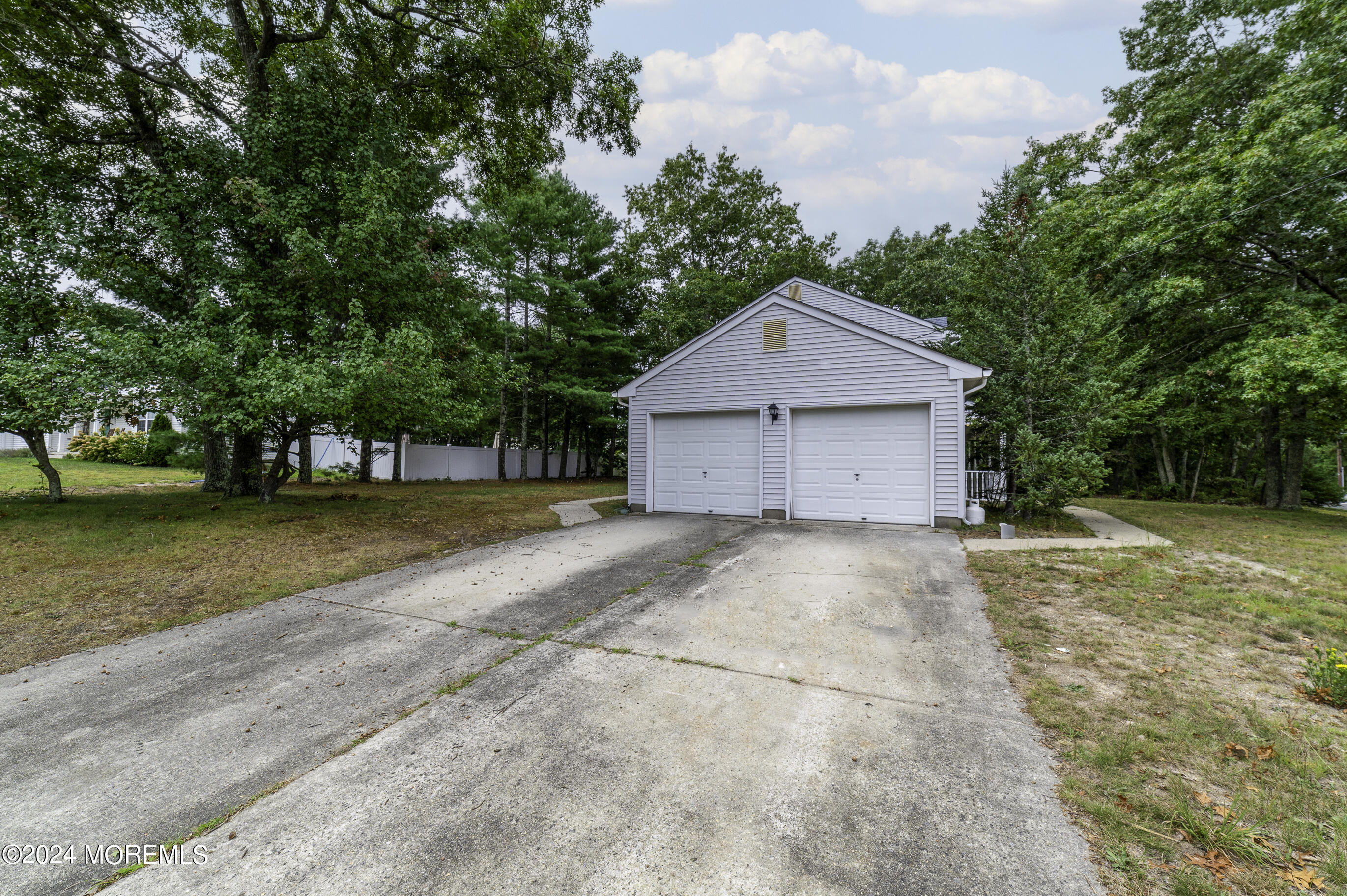 179 Wells Mill Road Waretown, NJ 08758 - Photo 28 of 28 a house with trees in front of it