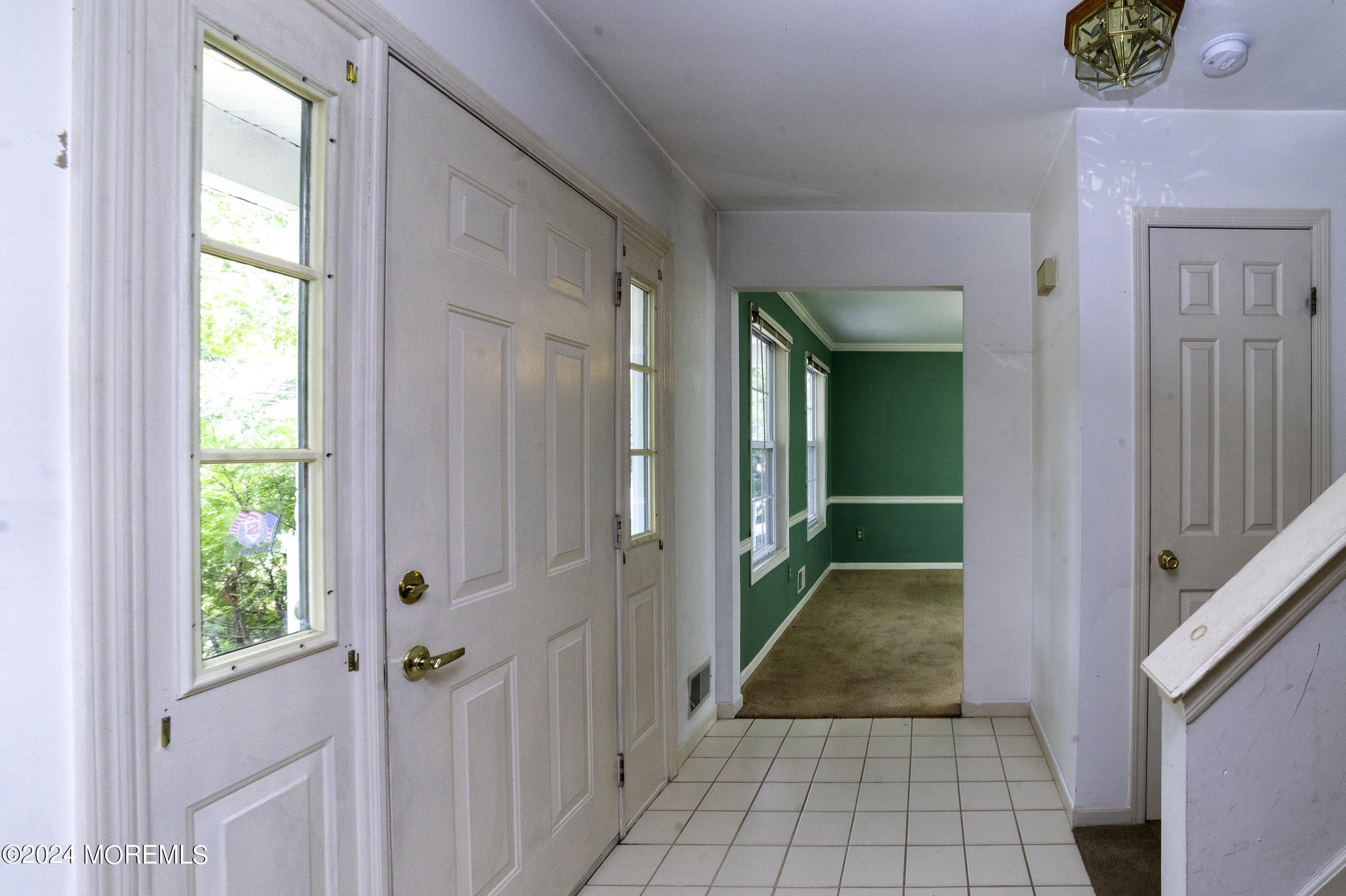 179 Wells Mill Road Waretown, NJ 08758 - Photo 4 of 28 a view of a hallway with wooden floor and a livingroom
