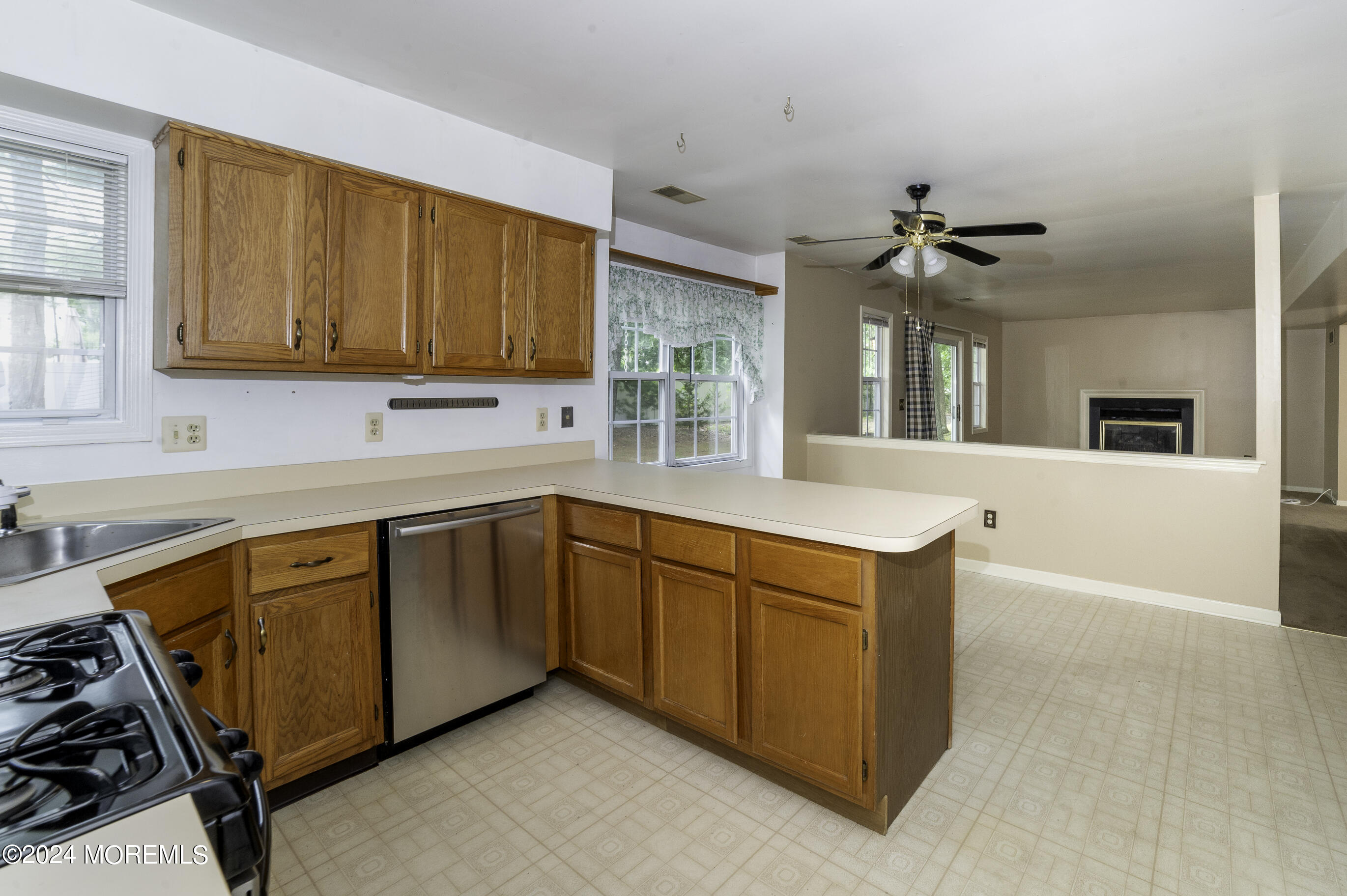 179 Wells Mill Road Waretown, NJ 08758 - Photo 6 of 28 a kitchen with stainless steel appliances granite countertop a sink a stove and a refrigerator